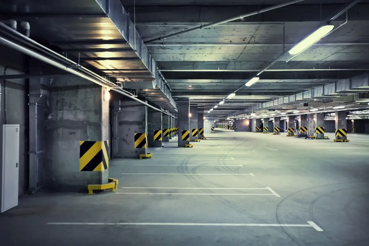 A dimly lit empty parking garage