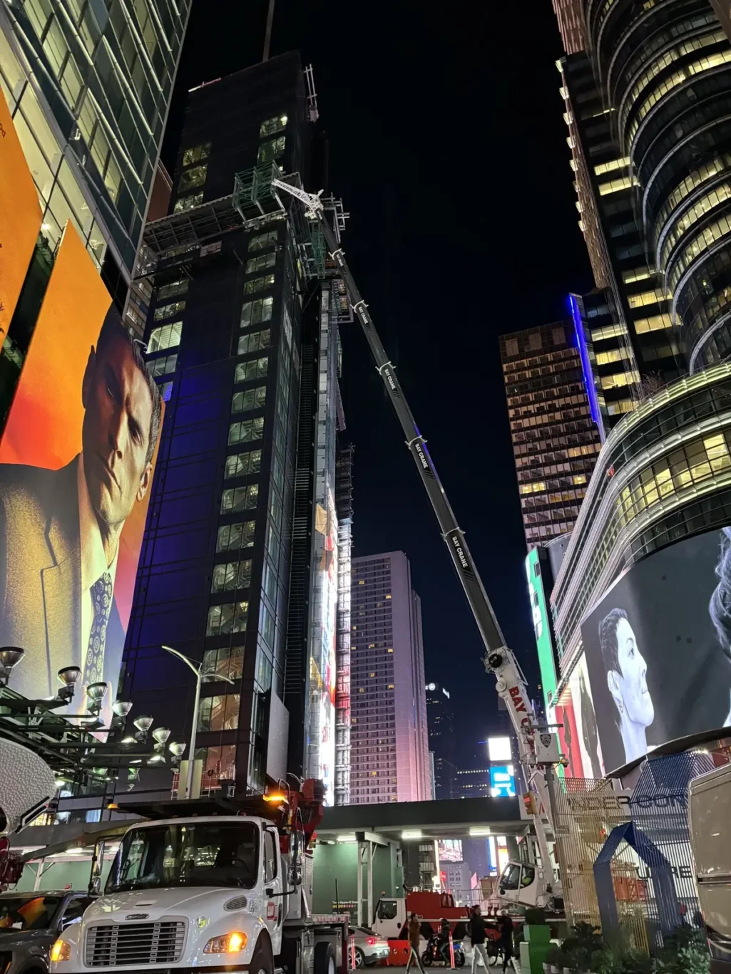 A nighttime view of cranes and construction equipment at One Times Square during redevelopment.