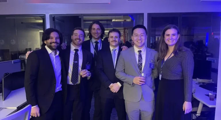 McLaren engineers posing for a photo at the 2025 AEC Connections Happy Hours