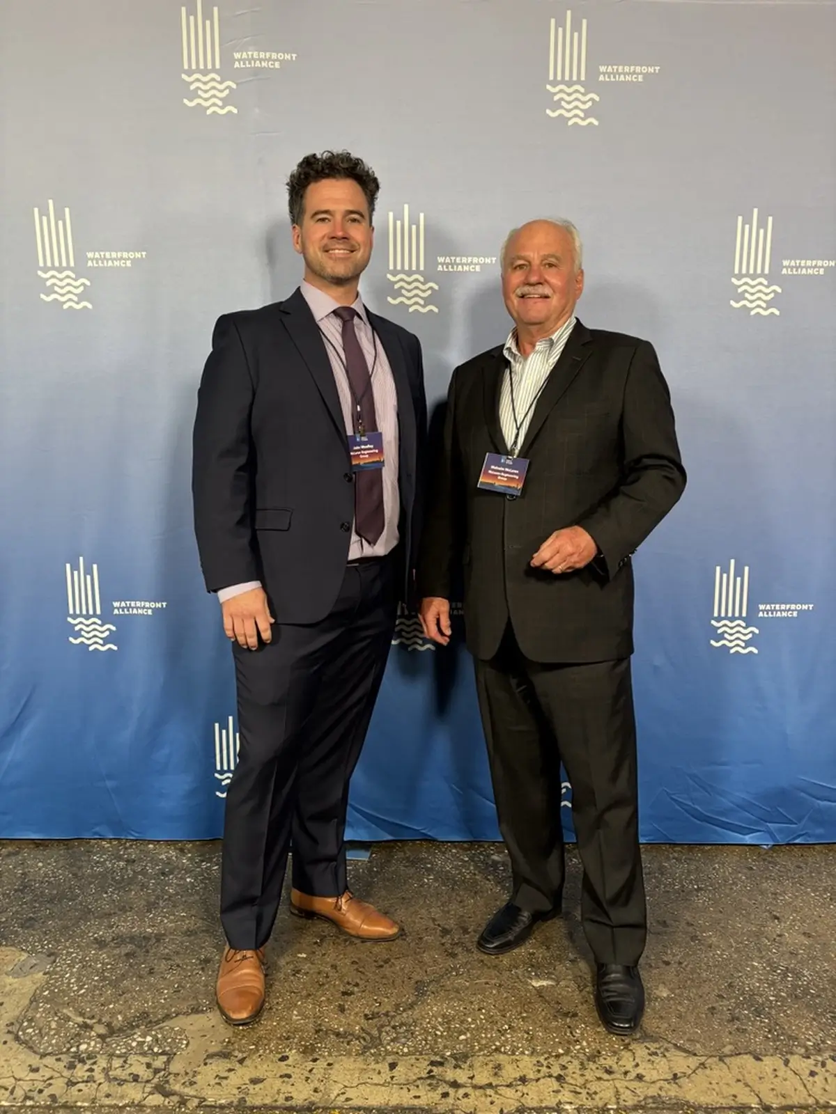 Malcolm McLaren, the founder of McLaren Engineering Group, stands next to Marine Principal JJ Woolley, posing for a photo at the Heroes of the Harbor 2024 gala.