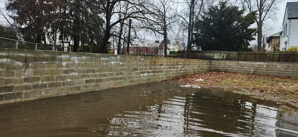 McLaren Engineering Performing a Drainage Assessment in Parking lot at Mount Vernon Highschool During Storm